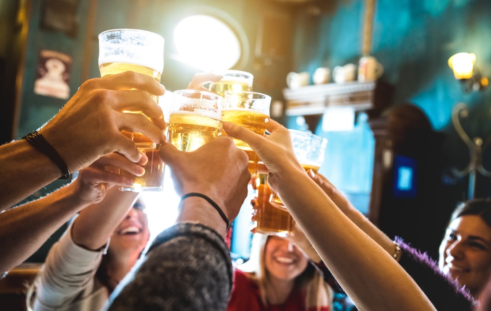 Group of people toasting beers , drunkest cities in america, cities that drink the most